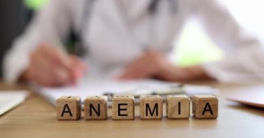 Anemia is written on wooden cubes on the doctor table, a close-up. Blood diseases, medical consultation