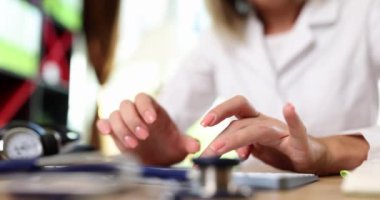 The female hands of the doctor are typed on the keyboard, close-up. Medical documentation, filling out the history patient