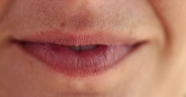 Macro female smiling mouth, slowmotion. White teeth, natural lips, without cosmetics, positive emotions
