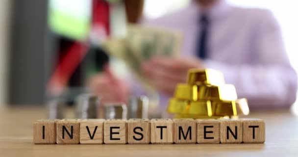 Investment Inscription Wooden Cubes Table Close Slowmotion Investor Considers Money — Stock video