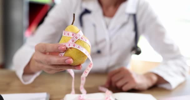 Young Female Hands Doctor Hold Yellow Pear Close Concept Weight — Stockvideo