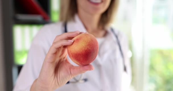 Happy Doctor Holds Peach Fruit Close Slowmotion Visit Nutritionist Diet — Wideo stockowe