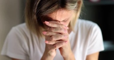 Woman bowing her head and reading morning prayer 4k movie slow motion. Religion and belief in god concept