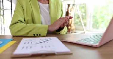 Businesswoman in suit clapping in front of laptop screen at business conference closeup 4k movie slow motion. Business negotiations online concept