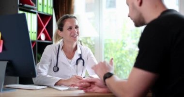 Patient telling complaints of doctor of therapist at reception in clinic 4k movie slow motion. Medical insurance concept