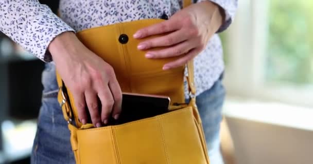 Woman Taking Mobile Phone Out Her Leather Purse Closeup Movie — Stockvideo