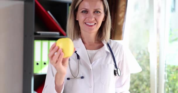 Smiling Doctor Nutritionist Holding Green Apple His Hands Movie Slow — Stockvideo