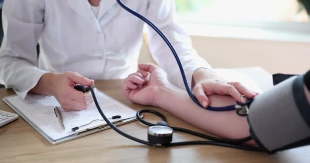 Doctor Measuring Blood Pressure Man Patient Using Tonometer Closeup Movie — Stock video