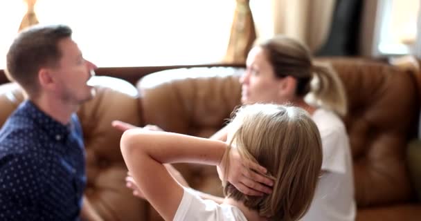 Little Girl Covering Her Ears Hands Quarrels Parents Back View — Stock Video