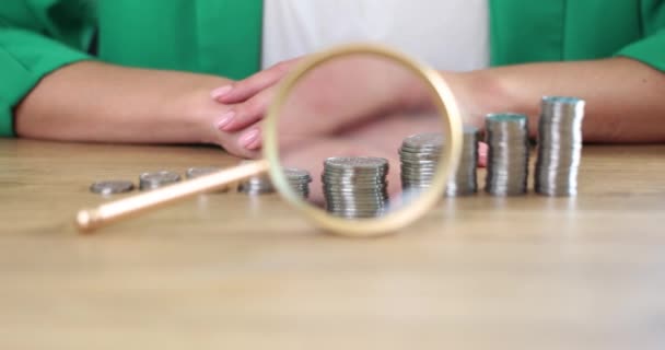 Magnifying Glass Lying Front Piles Coins Ascending Order Businesswoman Closeup — Wideo stockowe