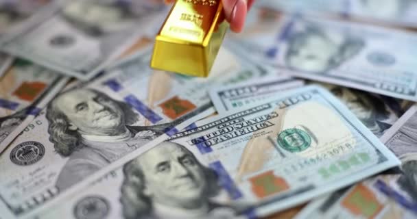 Woman Hand Putting Gold Bar Pile Dollar Bills Closeup Movie — Vídeos de Stock