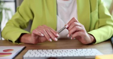 Businesswoman knocking with pen on hands and getting nervous closeup 4k movie slow motion. Making important business decisions concept