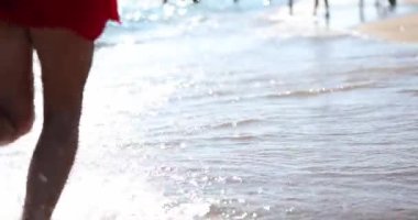 Young couple is running and having fun the sea. Lovers running barefoot on sea and on sand and summer vacation and beach concept