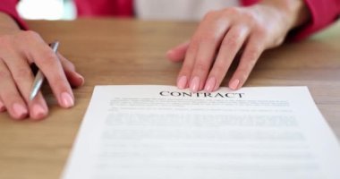 Signing legal contract or real estate purchase agreement. Agent hands over the contract and pens for signing