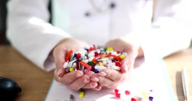 Hand of cardiologist therapist doctor holds bunch of different pills. Classification of medicines