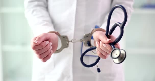Female Doctor Nurse Handcuffs Lab Coat Holds Stethoscope Responsibility Disclosure — Vídeo de Stock