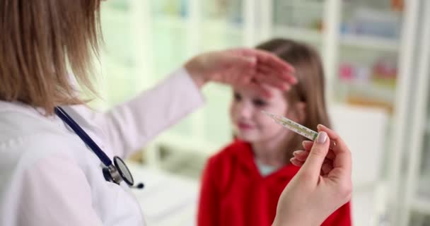 Doctor Checks Little Girl Temperature Thermometer Touches Forehead Hand High — Vídeos de Stock