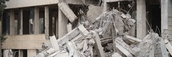 Destroyed cement building warrior rocket strike or earthquake. Explosion or destruction of buildings concept