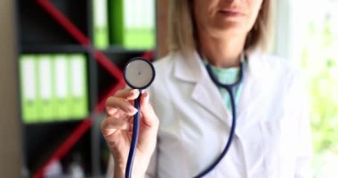 Hand of therapist woman holding stethoscope closeup. Medical care or insurance concept.