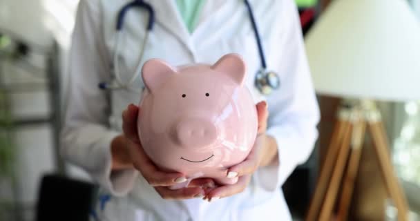 Doctor Holds Piggy Bank Health Insurance Hands Health Care Medicine — Wideo stockowe