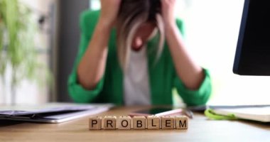 Exhausted and depressed woman and text problem on desk in office. Overworked woman manager lies on the office desk
