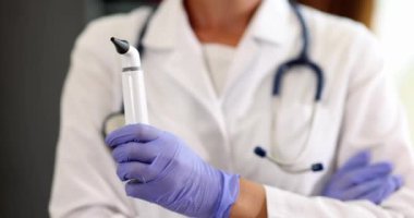 ENT doctor holds otoscope in hands to test hearing. Medical examination and tympanic membrane