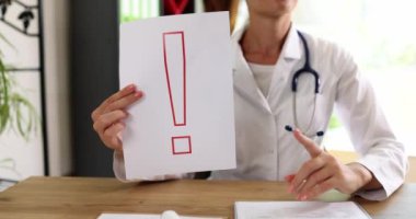 Doctor is holding finger up and an exclamation mark. Attention and medical services insurance