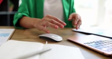 Female hand is holding pain in wrist from using computer. Office pain syndrome in hand with occupational disease