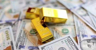 Dollar bill gold bullion and gold futures. Favorable investment interest and deposit and financial income