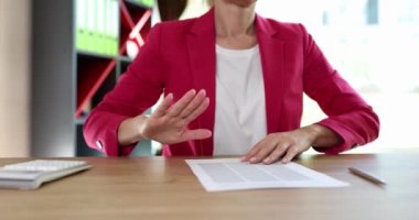 Hand of business woman refuses contract. Customer rejection gesture concept