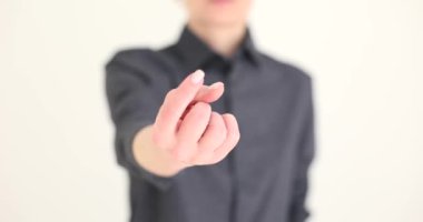 Hand of beautiful woman shows alluring gesture. Invite to call to attract attention