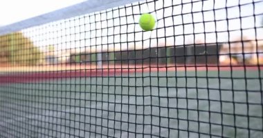 Tennis ball hits tennis net on tennis court. Tennis training