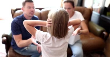 Father and mother scold daughter and family problems. Frightened child covering his ears and difficult family relationships