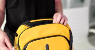 Woman tourist takes out cash dollars banknotes from backpack. Payment for services and goods traveling