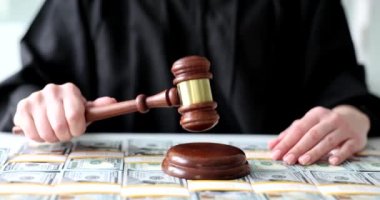 Judge with wooden gavel and many dollar bills. Court justice investigation and financial crime