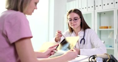 Doctor shows chest x-ray to patient. Inflammation of lungs and effects of smoking