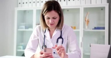Female doctor using mobile healthcare technology app. Nurse therapist consulting remote patient online in telemedicine software