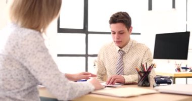 Employee shows documents to busy man manager. Seo gives extra work to intern performer