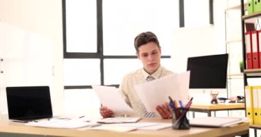 Businessman studies financial business documents in office. Business statistics and analytics