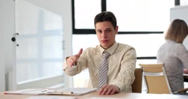 Young businessman student stretches out hands for handshake and greetings. Business partner and partnership agreements