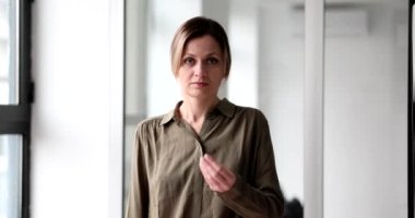 Beautiful woman shows a gesture with hands to give money. Free cash assistance