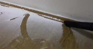 Master repairman collects white dust with construction vacuum cleaner. Remove construction dust after repair