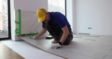 Master in floor installation and process of laying laminate on floor. Laying and repair of floors and floor coverings