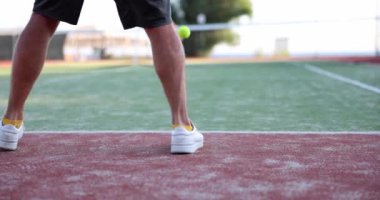 Tennis player serving ball playing on tennis court. Tennis game and coaching