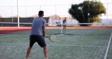 Athletic man and woman tennis player at tennis training. Healthy lifestyle and sports