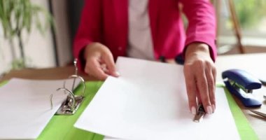 Woman secretary works with a4 documents and folders. Storage of business documents
