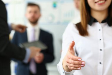 Portrait of a smiling business woman offering handshake. Friendly HR manager or team leader greeting or welcoming new employee