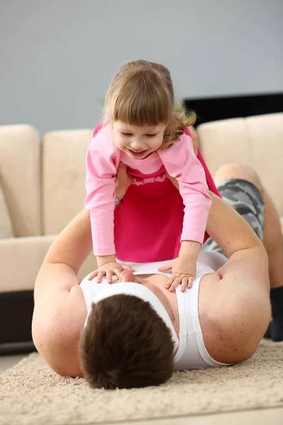 Joyful Young Father Man Lying Carpet Floor Lifting Excited Happy — Stock Photo, Image