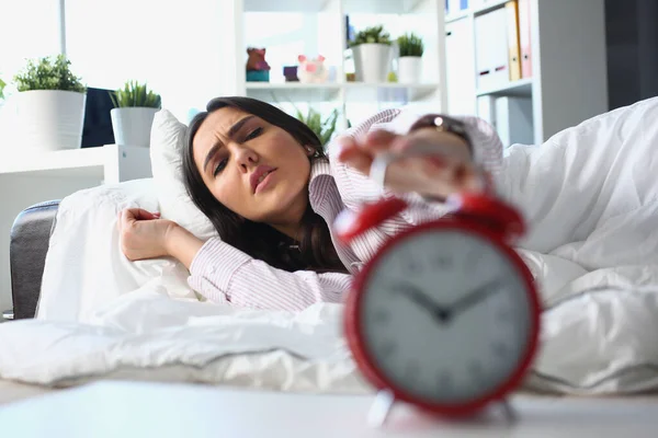 Dissatisfied Woman Lies Bed Turns Alarm Clock Irritated Young Woman — Stock Photo, Image