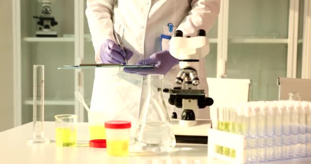 Laboratory Assistant Urine Sample Analysis Writes Medical Report Requirements Quality — Stock Video
